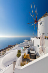 Wall Mural - Old white windmill in Oia in Santorini, Greece. Tradition white buildings of famous Santorini island