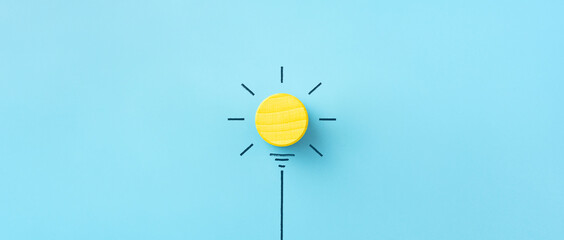 Wall Mural - Inspiration, Innovation concept, yellow wooden cube on blue background, copy space