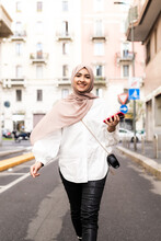 Young Muslim Woman Walking In City