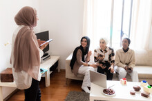 Four Young Muslim Women Together At Home