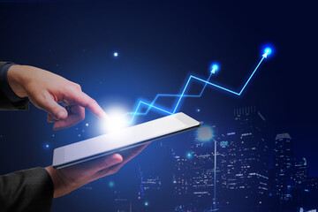 Poster - Make profitable business concept with man hand touching digital tablet screen and glowing light bulb with blue arrows up at city background
