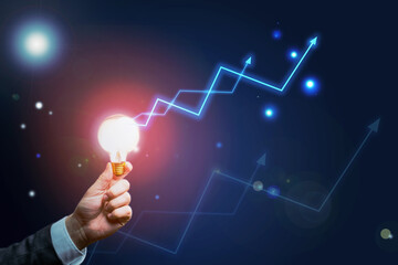 Poster - Concept idea and innovation concept with businessman carrying glowing light bulb and arrows up on abstract background