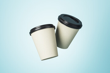 Poster - White paper coffee cups with black plastic caps with copyspace for your logo at light blue background. Mockup