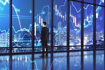 Aufkleber - Business investment success concept with businessman near the window, looking at night city skyscrapers and digital financial chart graphs