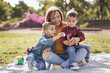 © Sabrina - Happy latin family having playful time together outdoor in nature park - Mother and twin sons enjoy day together - Family, mother and children love