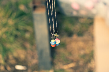 Wall Mural - Best friends necklace shoot outside in a summer day closeup. Selective Focus. High quality photo