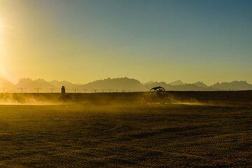 Unrecognizable people driving buggy during safari trip at sunset in Arabian desert not far from the Hurghada city, Egypt