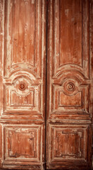 The cracked old wooden door in brown color. Texture background. Vintage interior.