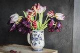 Fototapeta Tulipany - Tulip blooms fading, smooth texture, on a gray background