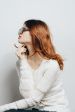 Fototapeta Konie - cute redhead woman white sweater fashion glamor cropped view