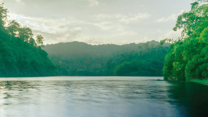 Wall Mural - Green texture background, green tone complete natural mountain water area Thailand.