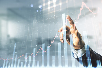 Poster - Multi exposure of businessman hand presses on virtual creative financial chart hologram on blurred office background, research and analytics concept