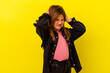 © Asier - Little caucasian girl isolated on yellow background covering ears with hands.