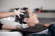 © charnsitr - Man getting hisr Hair Washed and in a Barber