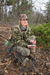 female turkey hunter wearing camouflage holding an aluminum slate call