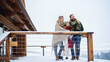 © Halfpoint - Family with small daughter on terrace outdoors, holiday in winter nature.