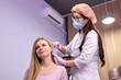 © alfa27 - female doctor trichologist conducts mesotherapy or plasma therapy to young woman patient. treatment of alopecia. hair loss, alopecia, pruritus, burning head or seborrhea