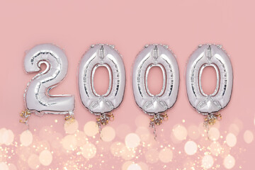 Balloon Bunting for celebration of 2000 made from Silver Number Balloons on pink background. Holiday Party Decoration or postcard concept with top view