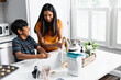 © Gerald Carter/Creative Flame - Indian mom and son washing hands in kitchen