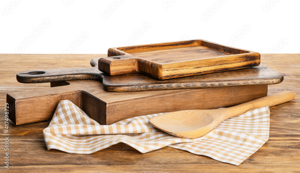 Wooden cutting boards and spatula on table against white background