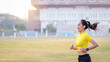 © EduLife Photos - A young Asian woman athlete runner jogging on running track in city stadium in the sunny morning to keep fitness and healthy lifestyle. Young fitness woman runs on stadium track. Sport and recreation