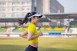 © EduLife Photos - A young Asian woman athlete runner jogging on running track in city stadium in the sunny morning to keep fitness and healthy lifestyle. Young fitness woman runs on stadium track. Sport and recreation