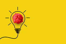 Creative Thinking Ideas And Innovation Concept. Paper Scrap Ball Red Colour With Light Bulb Symbol On Yellow Background