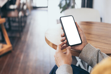 cell phone blank white screen mockup.woman hand holding texting using mobile on desk at office.background empty space for advertise.work people contact marketing business,technology