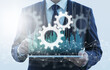 © tadamichi - Business process automation. Business person using tablet computer. Network structure and gear icons.