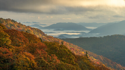 Wall Mural - Dramatic autumn weather - with clouds, fog and sun - on the southern Blue Ridge Parkway - Mountains - North Carolina	