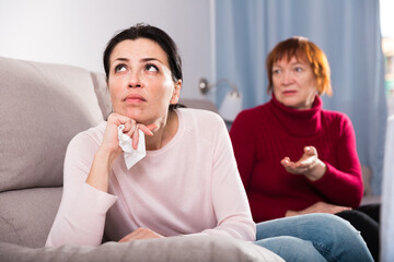 Portrait upset adult women looking away after conflict at home interior