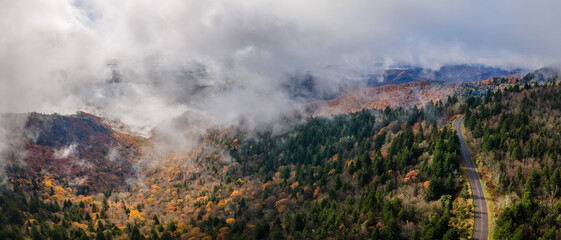 Wall Mural - Dramatic autumn weather - with clouds, fog and sun - in the Blue Ridge Mountains