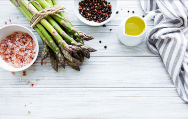 Bunch of raw asparagus stems with different spices