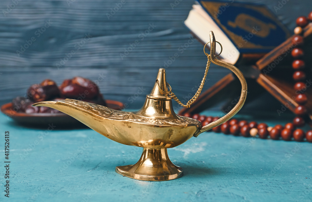 Aladdin lamp of wishes on color background