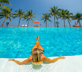 woman in luxury spa resort near the swimming pool.