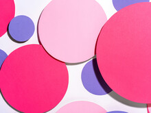 Background Of Colorful Paper Circles In Memphis Geometric Style. Cut Out Pink And Purple Circles Styled Layout With Hard Light And Shadows. Vivid Abstract Background Or Template
