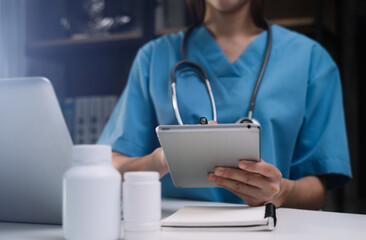 Pharmacist writing on clipboard and holding medication in the clinic.