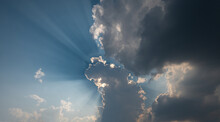 Sun Shines Behind The Cumulus Clouds.Sun Hiding Behind A Cloud On The Day Sky.