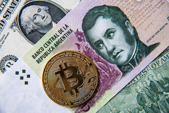 Wall Mural -  - Bitcoin against argentinian peso and american dollar, close-up image. Conceptual image of digital crypto currency against world traditional currencyies