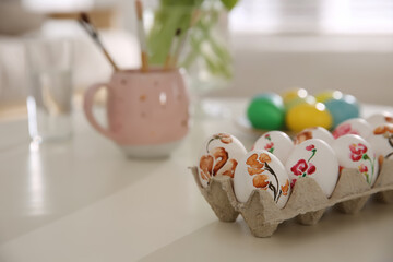 Wall Mural - Beautifully painted Easter eggs on white table indoors, space for text