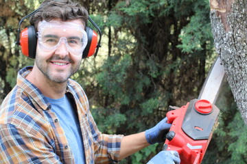 Wall Mural - Candid of lumberjack holding a chainsaw 