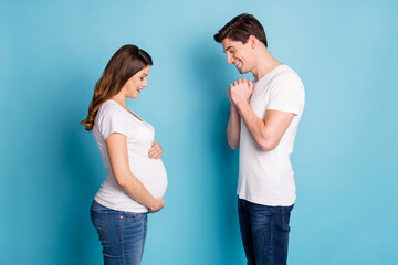 Poster - Profile photo of nice young family look stomach good mood cant wait child isolated on blue color background