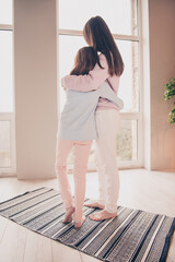 Poster - Vertical rear back behind full length body size view of nice affectionate girls embracing looking at window sunrise at house flat indoor