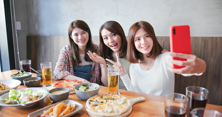 Wall Mural - friends take selfie in restaurant