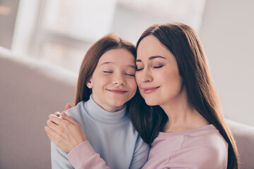 Poster - Photo of optimistic brunette red hairdo mom daughter hug sit on sofa wear sweater at home