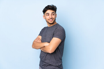 Arabian handsome man over isolated background with arms crossed and happy