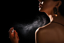 Woman Spraying Luxury Perfume On Black Background, Closeup
