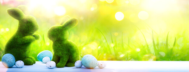 Art Happy Easter Day Holidays banner background; Easter rabbit Bunny And Decorated Eggs In Flowery Field;