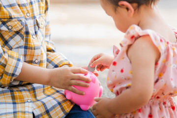 Poster - Little girl coin operated Into a piggy bank for saving money
