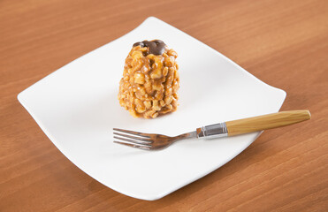 Delicious freshly baked anthill with plate and fork on a wooden table.